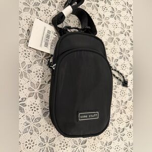 A black crossbody phone bag, similar in style to small sling bag